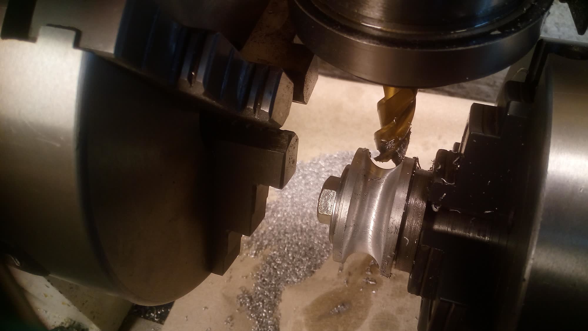 Milling cutter working a metal part on a rotary table