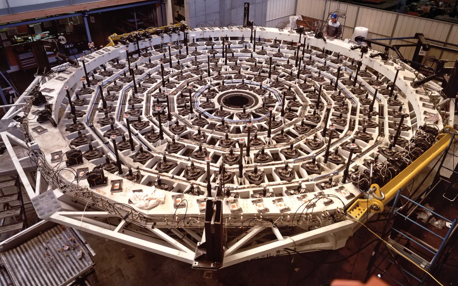 Large welded steel fixture with an engineer standing at its edge