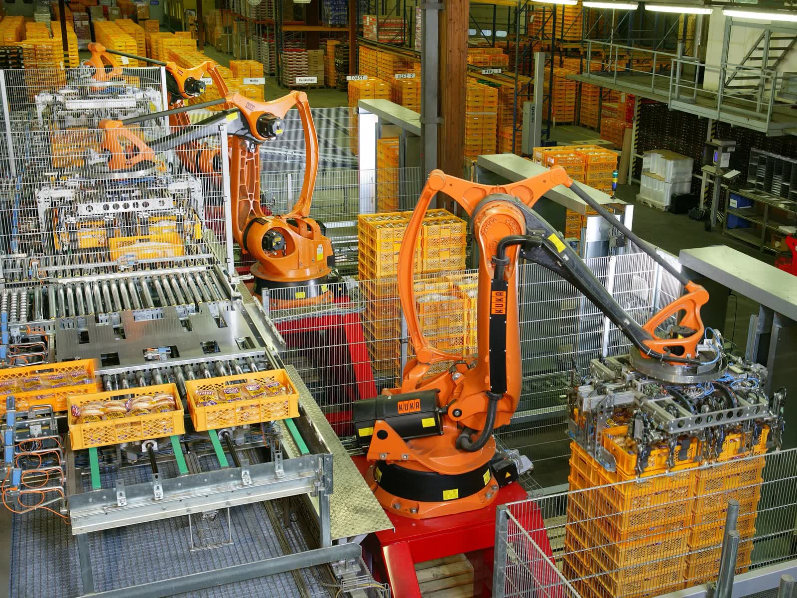 Robots handling crates on an automated line